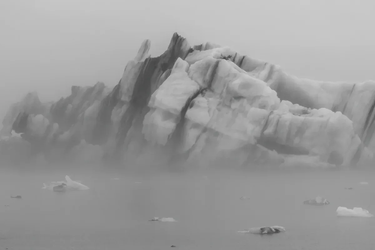 Iceberg in fog on Jökulsárlón, the weather to expect on a glacier lagoon boat tour